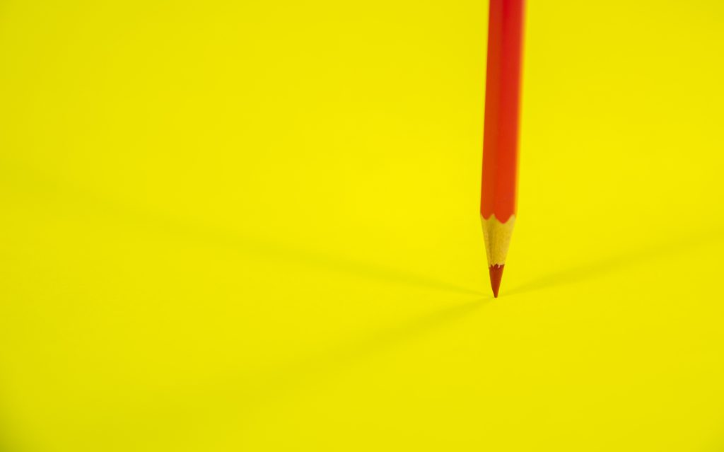 Header image: sharp red pencil on bright yellow background (credit: GR Stocks / Shutterstock.com)