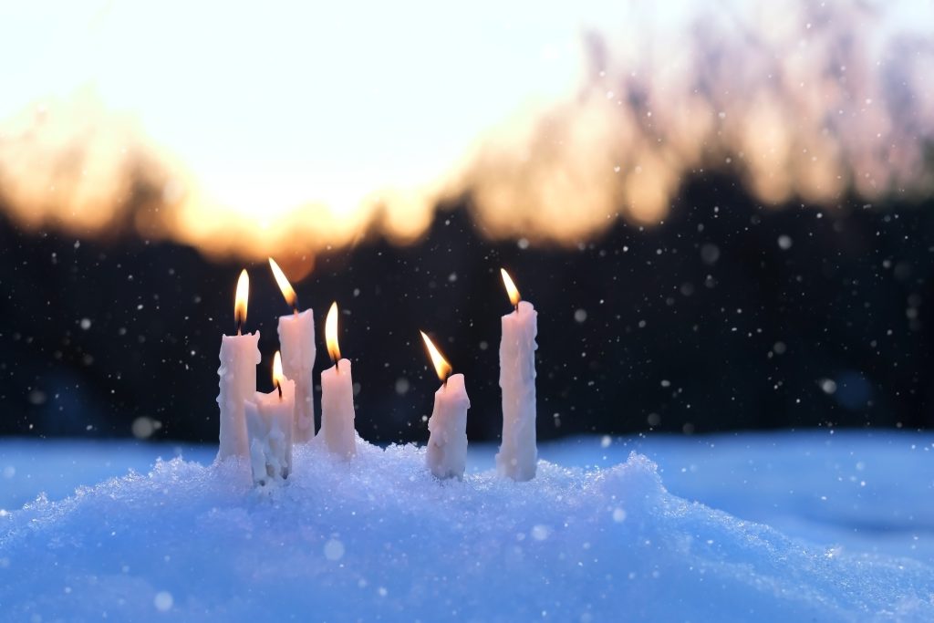 Header image: candles burning in the snow