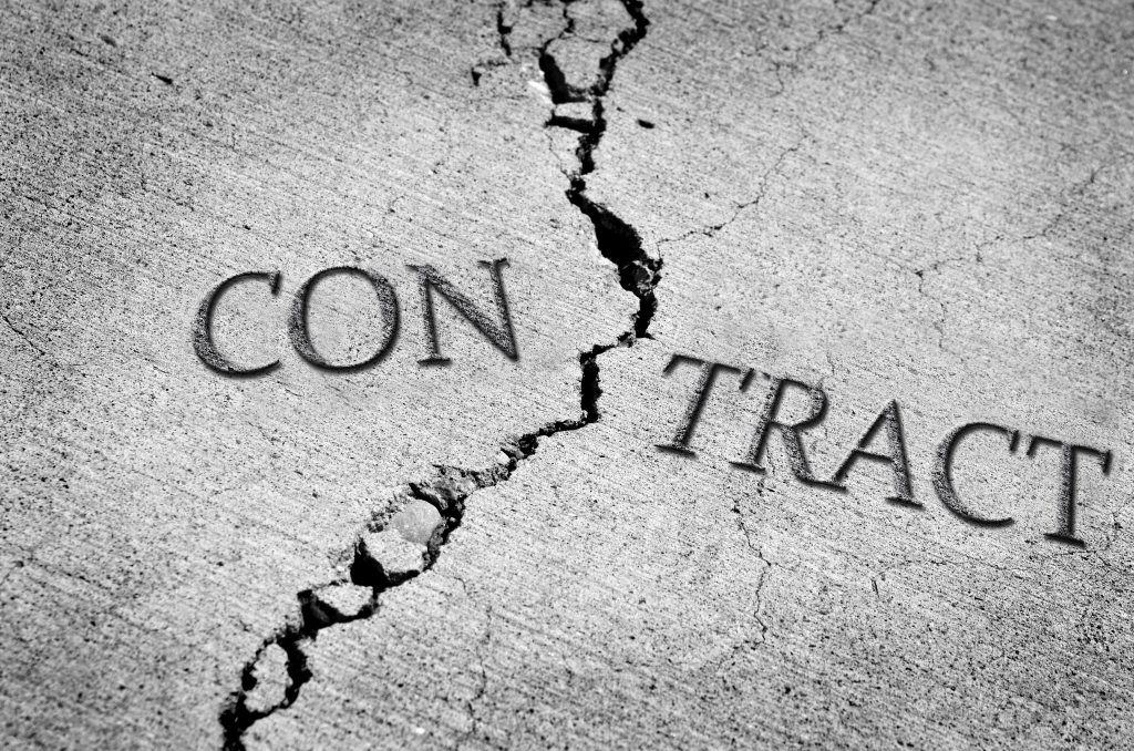 Header image: the word Contract etched in concrete, with a crack between "Con" and "Tract" dividing the word (Credit: Lane V. Erickson / Shutterstock.com)